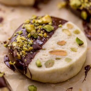 Dark Chocolate Pistachio Slice & Bake Cookies are so easy and made with just 6 ingredients! These buttery shortbread cookies are loaded with pistachios and then dunked in dark chocolate. So good with a cup of coffee or tea! 