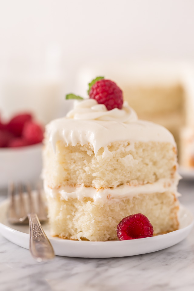 This is the BEST white cake recipe you'll ever bake! Each slice is moist, fluffy, and so delicious. This tender snow-white cake is made completely from scratch and with simple ingredients!