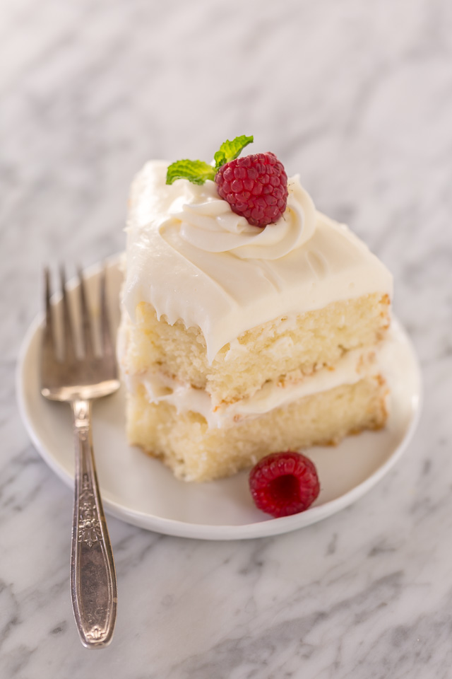 This is the BEST white cake recipe you'll ever bake! Each slice is moist, fluffy, and so delicious. This tender snow-white cake is made completely from scratch and with simple ingredients!
