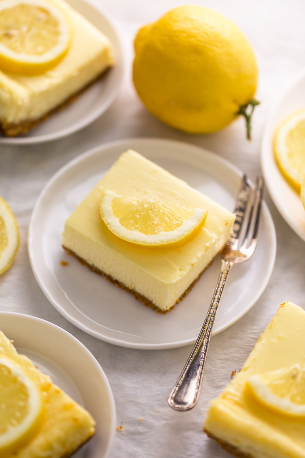 Easy Lemon Cheesecake Bars are perfect for almost any occasion! Made with fresh lemon juice, lemon zest, cream cheese, and sour cream, they're tangy, sweet, and so delicious. A must try for lemon lovers!