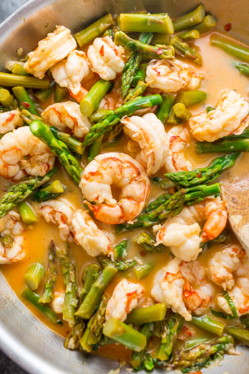 This quick and easy Lemon Garlic Shrimp and Asparagus is ready in less than 20 minutes! This one pan meal is exploding with flavor and always a crowd-pleaser. So next time you're looking for a healthy dinner, give this garlic shrimp and asparagus a try!