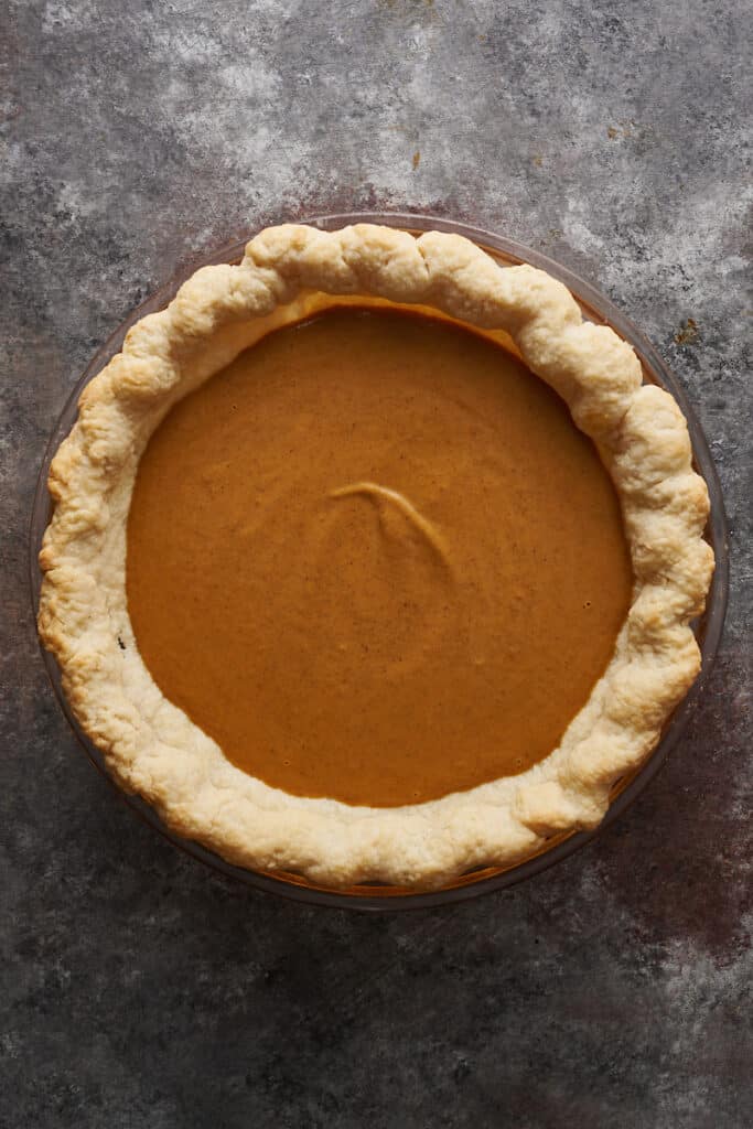 Blind baked pie shell filled with pumpkin pie filling. 