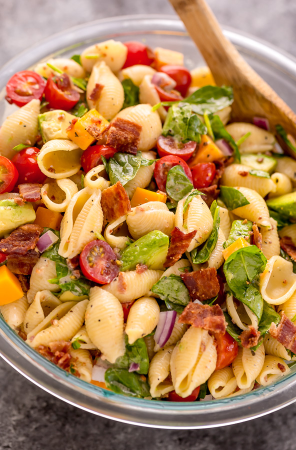 This Creamy Avocado BLT Pasta Salad is so easy and perfect for Summer celebrations! Loaded with crispy bacon, juicy tomatoes, spinach, avocado, and cheddar cheese. This flavorful pasta salad is always a crowd-pleaser!