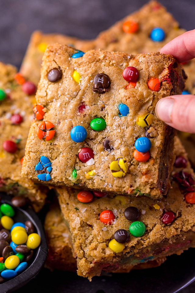 Easy M&M Cookie Bars are soft, chewy, and so delicious! Loved by kids and adults, these are perfect for bake sales, potlucks, and holiday baking! Just like my brown butter M&M cookies, but so much easier!