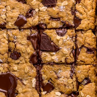 These are the BEST Oatmeal Cookie Bars you'll ever bake! Soft, chewy, and loaded with rolled oats and chocolate, this is a great recipe the whole family will love! Super easy and no mixer required!