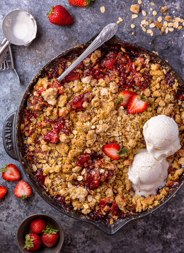 This Easy Strawberry Crisp is the perfect Summer dessert! Featuring plenty of juicy strawberries and a golden brown oatmeal crisp topping, it's best served warm... with a big scoop of vanilla ice cream on top! Can be made with fresh or frozen strawberries!