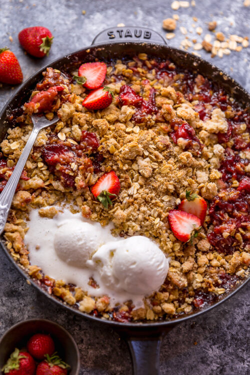 This Easy Strawberry Crisp is the perfect Summer dessert! Featuring plenty of juicy strawberries and a golden brown oatmeal crisp topping, it's best served warm... with a big scoop of vanilla ice cream on top! Can be made with fresh or frozen strawberries!