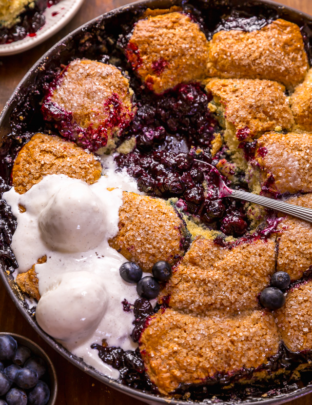 When blueberries go on sale, stock up so you can make this quick and easy blueberry cobbler recipe! Featuring the juiciest blueberry filling and a buttery biscuit topping, this Summer dessert is so good with a scoop of vanilla ice cream on top! While I always prefer to use fresh fruit, this recipe will work with fresh or frozen blueberries! #blueberrycobbler