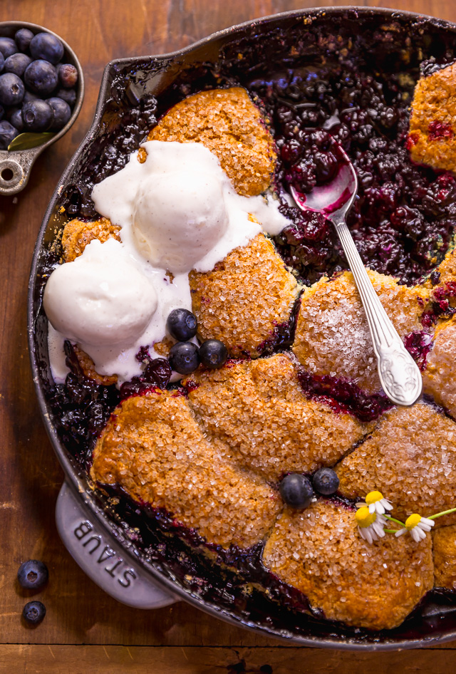 When blueberries go on sale, stock up so you can make this quick and easy blueberry cobbler recipe! Featuring the juiciest blueberry filling and a buttery biscuit topping, this Summer dessert is so good with a scoop of vanilla ice cream on top! While I always prefer to use fresh fruit, this recipe will work with fresh or frozen blueberries! #blueberrycobbler