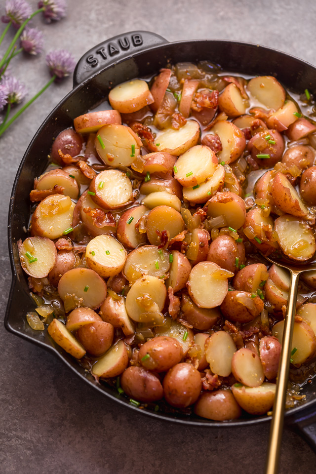 I had my first taste of German Potato Salad 7 years ago and it was love at first bite! It's made with baby red potatoes, yellow onion, and an apple cider vinegar dressing consisting of salt, pepper, mustard, and sugar. And then it's topped with cooked bacon, chopped chives, and a drizzle of olive oil! This potato salad is served warm and makes a great side dish! #potatosalad #Germanpotatosalad 