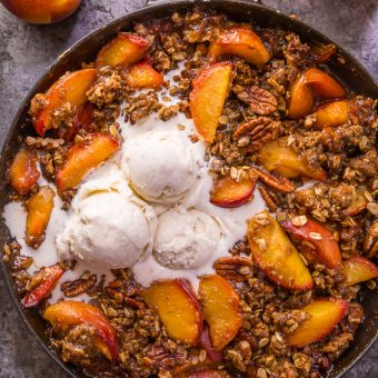 In my humble opinion, the only thing better than peach crisp is BOURBON PECAN PEACH CRISP! Made with brown sugar, fresh peaches, bourbon, and a touch of cinnamon, this is Summer in a baking dish! Serve warm while the fruit is bubbling, with a big scoop of vanilla ice cream on top! #peachcrisp #bourbonpecan #bourbonpeachpie #peaches #peachrecipes