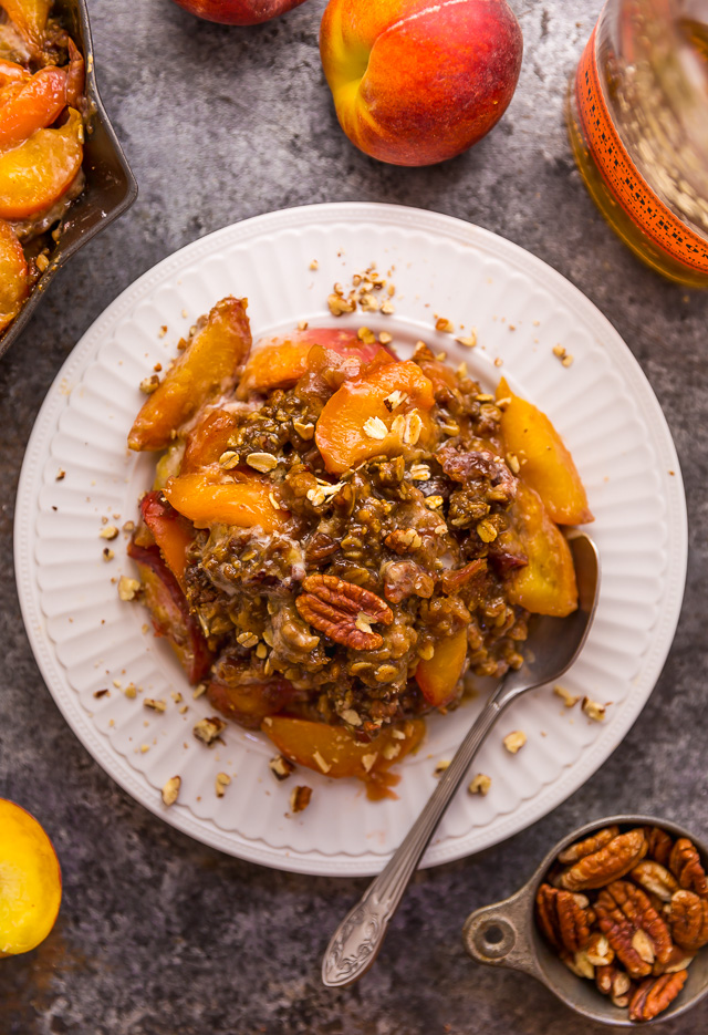 In my humble opinion, the only thing better than peach crisp is BOURBON PECAN PEACH CRISP! Made with brown sugar, fresh peaches, bourbon, and a touch of cinnamon, this is Summer in a baking dish! Serve warm while the fruit is bubbling, with a big scoop of vanilla ice cream on top! #peachcrisp #bourbonpecan #bourbonpeachpie #peaches #peachrecipes