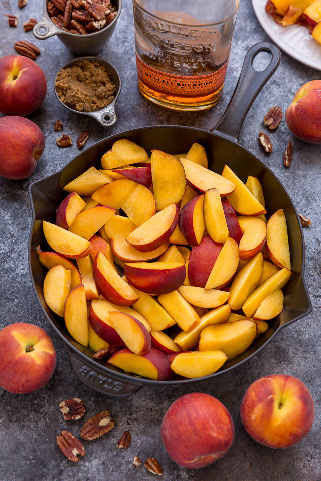 In my humble opinion, the only thing better than peach crisp is BOURBON PECAN PEACH CRISP! Made with brown sugar, fresh peaches, bourbon, and a touch of cinnamon, this is Summer in a baking dish! Serve warm while the fruit is bubbling, with a big scoop of vanilla ice cream on top! #peachcrisp #bourbonpecan #bourbonpeachpie #peaches #peachrecipes