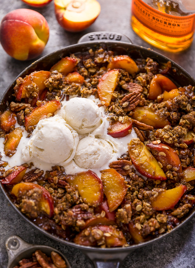 In my humble opinion, the only thing better than peach crisp is BOURBON PECAN PEACH CRISP! Made with brown sugar, fresh peaches, bourbon, and a touch of cinnamon, this is Summer in a baking dish! Serve warm while the fruit is bubbling, with a big scoop of vanilla ice cream on top! #peachcrisp #bourbonpecan #bourbonpeachpie #peaches #peachrecipes