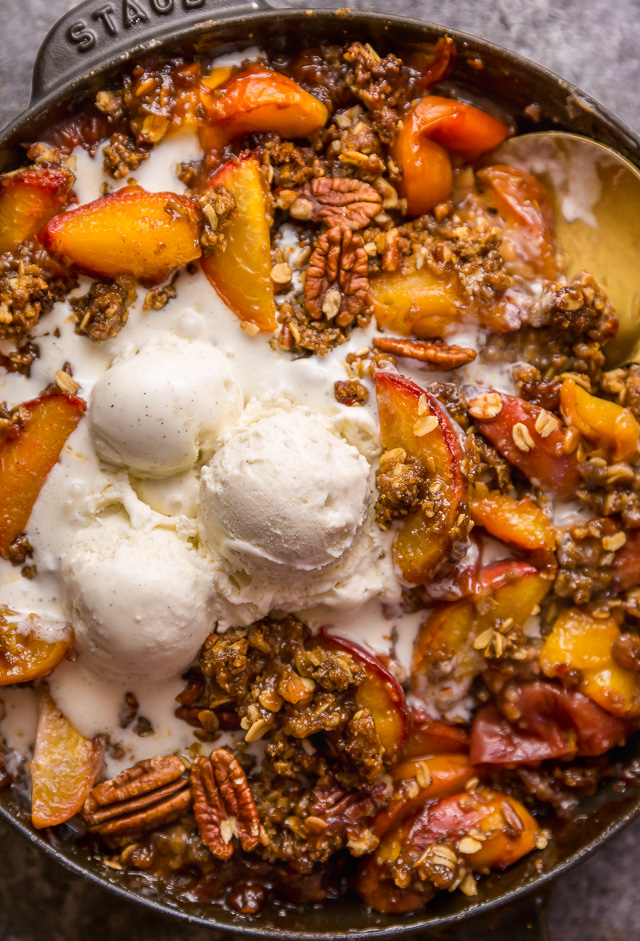 In my humble opinion, the only thing better than peach crisp is BOURBON PECAN PEACH CRISP! Made with brown sugar, fresh peaches, bourbon, and a touch of cinnamon, this is Summer in a baking dish! Serve warm while the fruit is bubbling, with a big scoop of vanilla ice cream on top! #peachcrisp #bourbonpecan #bourbonpeachpie #peaches #peachrecipes