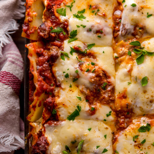 The Best Homemade Lasagna Recipe is cheesy, meaty, saucy, and SO delicious!!! And while this recipe requires a bit of work, it can be made ahead of time and stored in the fridge for up to 24 hours before baking. A hearty recipe that's perfect for feeding large groups! #lasagna #lasagnarecipe