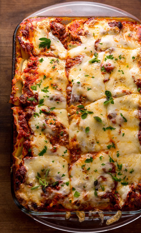 The Best Homemade Lasagna Recipe is cheesy, meaty, saucy, and SO delicious!!! And while this recipe requires a bit of work, it can be made ahead of time and stored in the fridge for up to 24 hours before baking. A hearty recipe that's perfect for feeding large groups! #lasagna #lasagnarecipe 