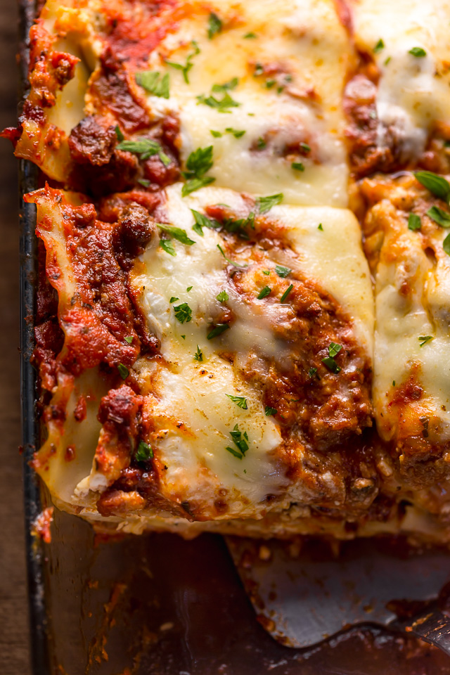 The Best Homemade Lasagna Recipe is cheesy, meaty, saucy, and SO delicious!!! And while this recipe requires a bit of work, it can be made ahead of time and stored in the fridge for up to 24 hours before baking. A hearty recipe that's perfect for feeding large groups! #lasagna #lasagnarecipe 