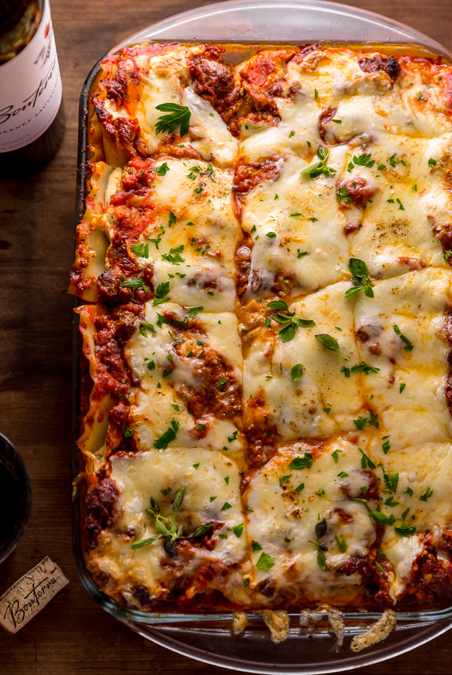 The Best Homemade Lasagna Recipe is cheesy, meaty, saucy, and SO delicious!!! And while this recipe requires a bit of work, it can be made ahead of time and stored in the fridge for up to 24 hours before baking. A hearty recipe that's perfect for feeding large groups! #lasagna #lasagnarecipe 