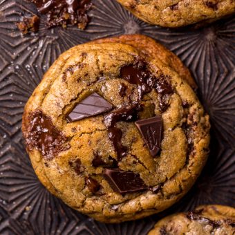 Whiskey lovers will go crazy for these Rye Whiskey Chocolate Chip Cookies! Made with a unique combination of rye flour and all purpose flour, they bake up soft, chewy, and ultra thick! Brown butter, rye whiskey, and plenty of chocolate make these grown up chocolate chip cookies totally irresistible!