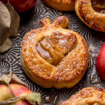 Apple hand pies on a baking sheet.