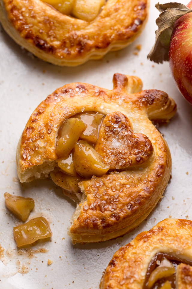 The only thing better than apple pie is cute little apple hand pies!!! Featuring apple shaped homemade pie crust and gooey apple pie filling, these individual apple pies bake up in about 15 minutes! The perfect apple hand pies to for share with loved ones this holiday season.