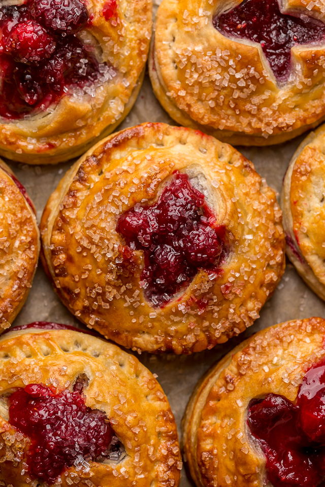 Rustic Cranberry Hand Pies feature a flaky crust and a delicious orange cranberry filling! And their petite handheld size makes them perfect for sharing this holiday season! It's just not Christmas in our house without these on the table!