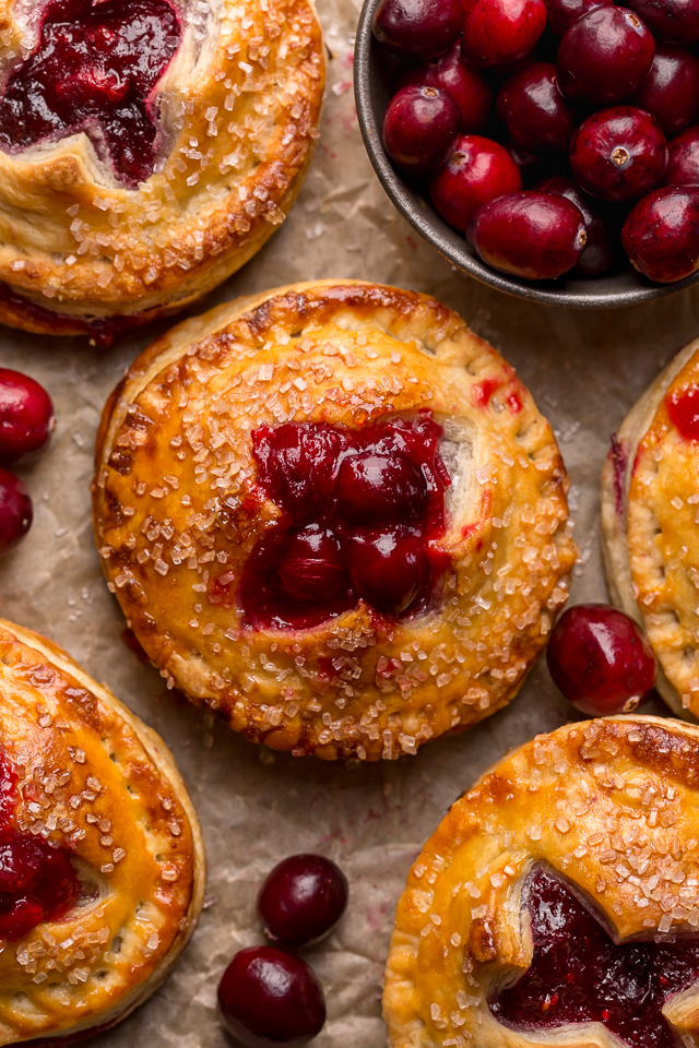 Rustic Cranberry Hand Pies feature a flaky crust and a delicious orange cranberry filling! And their petite handheld size makes them perfect for sharing this holiday season! It's just not Christmas in our house without these on the table!