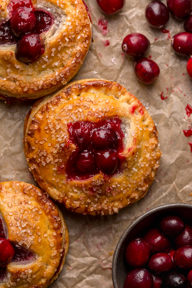 Rustic Cranberry Hand Pies feature a flaky crust and a delicious orange cranberry filling! And their petite handheld size makes them perfect for sharing this holiday season! It's just not Christmas in our house without these on the table!
