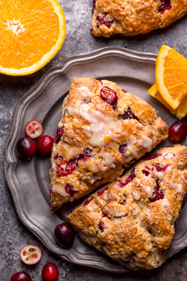 Cranberry Orange Scones are loaded with vibrant orange flavor, fresh cranberries, and topped with a sweet orange glaze! Perfect for breakfast or brunch! And one of my favorite scone recipes to make during the holiday season!