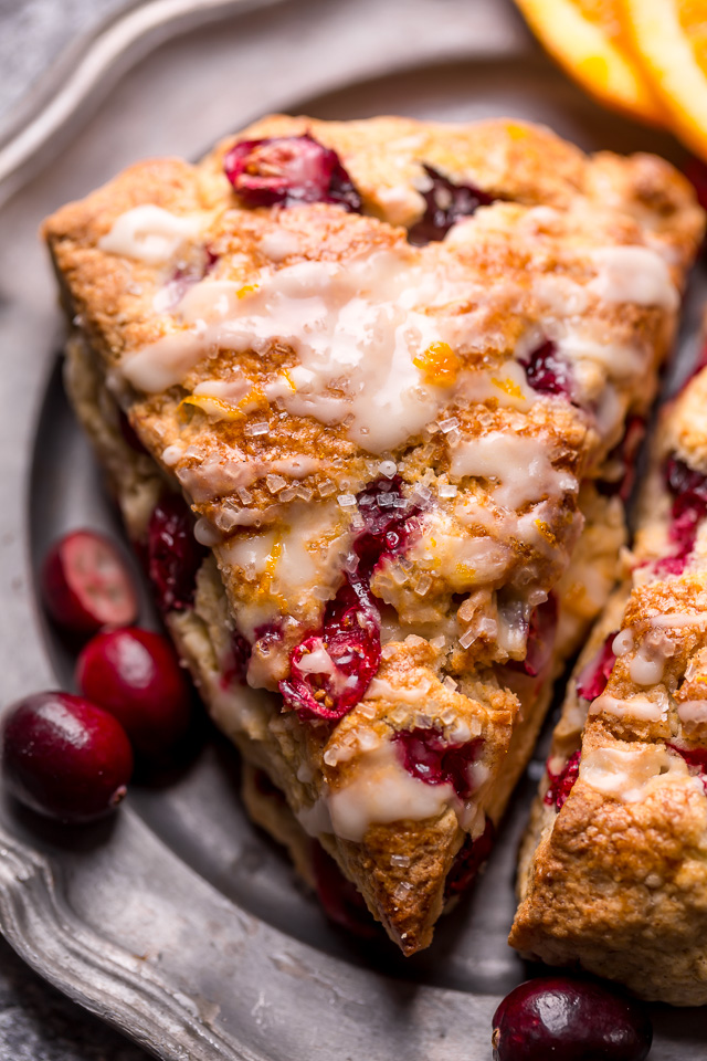 Cranberry Orange Scones are loaded with vibrant orange flavor, fresh cranberries, and topped with a sweet orange glaze! Perfect for breakfast or brunch! And one of my favorite scone recipes to make during the holiday season!