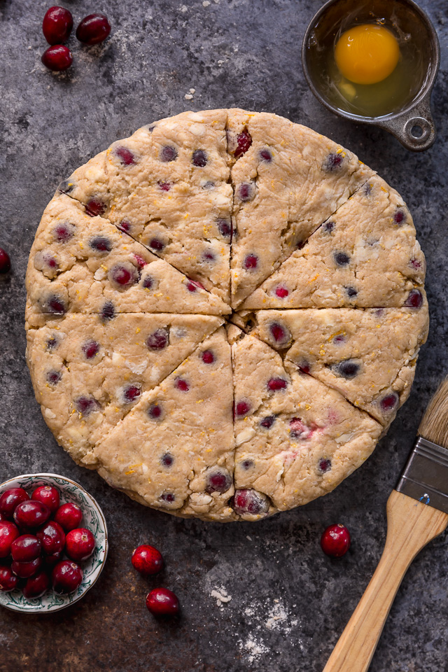 Cranberry Orange Scones are loaded with vibrant orange flavor, fresh cranberries, and topped with a sweet orange glaze! Perfect for breakfast or brunch! And one of my favorite scone recipes to make during the holiday season!