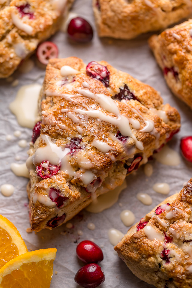 Cranberry Orange Scones are loaded with vibrant orange flavor, fresh cranberries, and topped with a sweet orange glaze! These are so festive and perfect for breakfast or brunch. And one of my favorite scone recipes to make during the holiday season!
