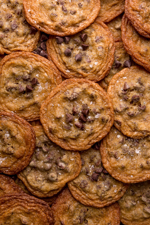 Bust out your cookie sheet, because these thin crispy chocolate chip cookies are a must bake! These cookies bake up golden brown and smell like heaven! Super thin and delightful crisp, these are one of our favorite chocolate chip cookie recipes!