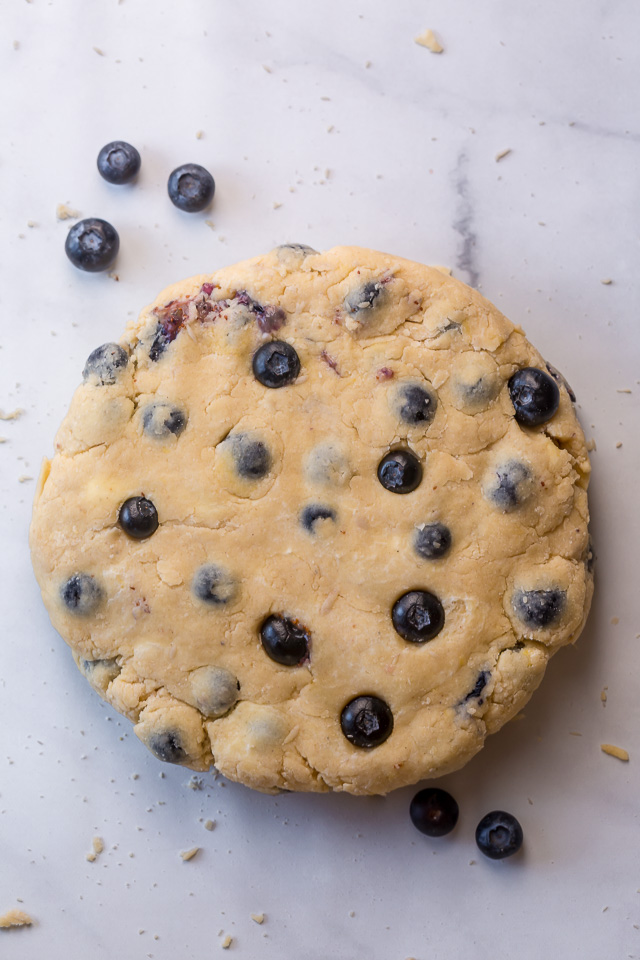 These Classic Bakery-Style Blueberry Scones are sweet, buttery, and exploding with fresh blueberries! Topped with sparkling coarse sugar and a sweet vanilla glaze, these are perfect for breakfast or brunch! Even scone haters love this recipe!