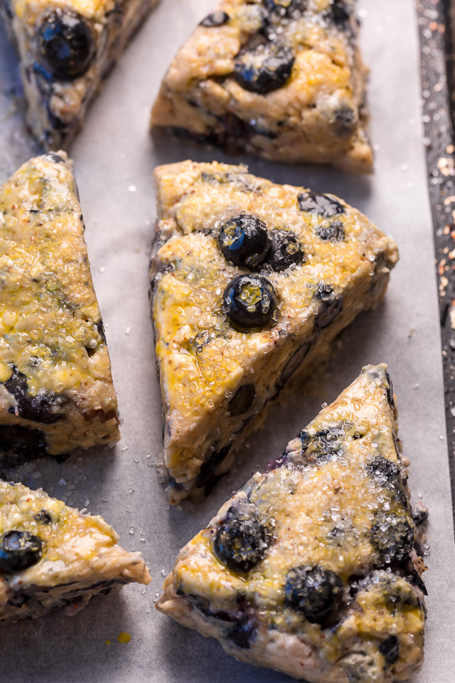 These Classic Bakery-Style Blueberry Scones are sweet, buttery, and exploding with fresh blueberries! Topped with sparkling coarse sugar and a sweet vanilla glaze, these are perfect for breakfast or brunch! Even scone haters love this recipe!