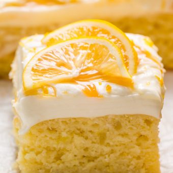 My lemon cake for a crowd is moist, fluffy, and loaded with fresh lemon flavor! Topped with silky smooth lemon cream cheese frosting, dollops of lemon curd, and fresh lemon slices, this is one of my most popular lemon desserts. Bonus: this lemon sheet cake is so easy and feeds a crowd!