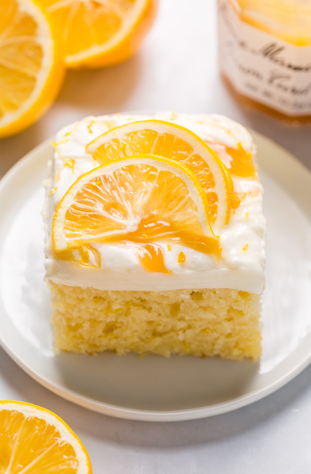 My lemon cake for a crowd is moist, fluffy, and loaded with fresh lemon flavor! Topped with silky smooth lemon cream cheese frosting, dollops of lemon curd, and fresh lemon slices, this is one of my most popular lemon desserts. Bonus: this lemon sheet cake is so easy and feeds a crowd!