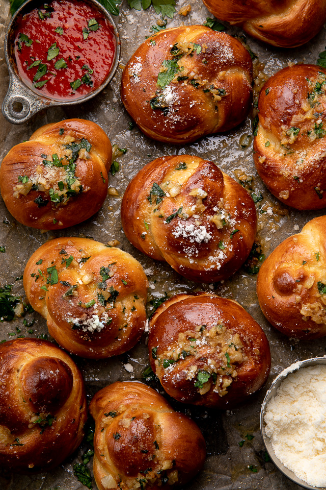 Soft Pretzel Garlic Knots are chewy, flavorful, and so delicious! Made with a simple soft pretzel dough, they're shaped like knots and baked until golden brown. Then topped with garlic butter and parmesan cheese!