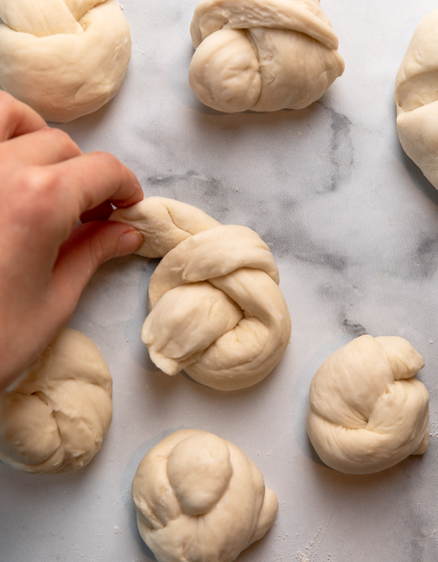 Soft Pretzel Garlic Knots are chewy, flavorful, and so delicious! Made with a simple soft pretzel dough, they're shaped like knots and baked until golden brown. Then topped with garlic butter and parmesan cheese!