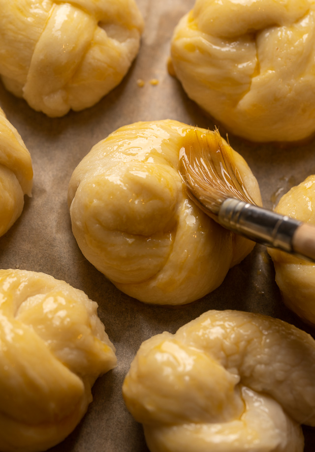 Soft Pretzel Garlic Knots are chewy, flavorful, and so delicious! Made with a simple soft pretzel dough, they're shaped like knots and baked until golden brown. Then topped with garlic butter and parmesan cheese!