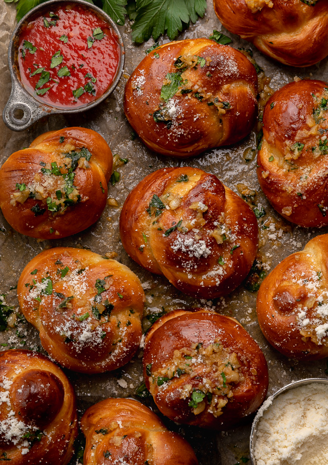 Soft Pretzel Garlic Knots are chewy, flavorful, and so delicious! Made with a simple soft pretzel dough, they're shaped like knots and baked until golden brown. Then topped with garlic butter and parmesan cheese!