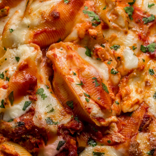 These Crazy Good Classic Stuffed Shells are creamy, gooey, carb-y comfort food at it's best! This family loved recipe features perfectly cooked shells, flavorful tomato sauce, and the most delicious ricotta filling! Sure to become one of your favorite pasta dishes!