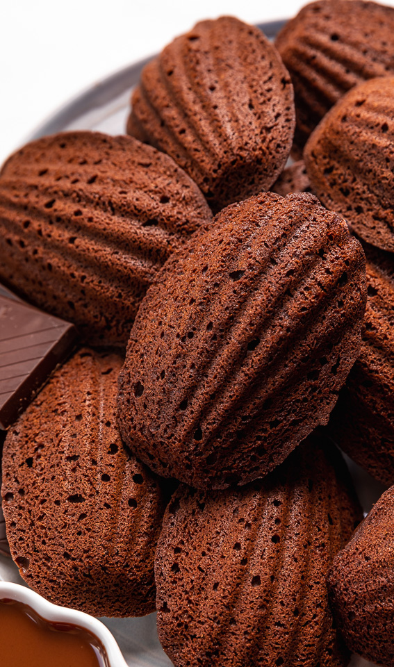 My Double Chocolate Madeleines are fluffy, cakey, and perfect for dunking in tea or coffee! A sweet treat that's sure to please the chocolate lovers in your life! So bust out your madeleine pan and let's get baking!