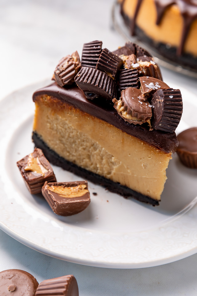 This Chocolate Covered Peanut Butter Cheesecake is ultra creamy and the perfect marriage of chocolate and peanut butter! Featuring an oreo crust, creamy peanut butter cheesecake filling, and topped with with peanut butter chocolate ganache and peanut butter cups, it's a true showstopper! And any leftovers freeze great!