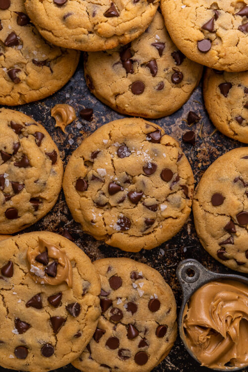 These Bakery-Style Chocolate Chip Cookies are super thick, rich in peanut butter flavor, and loaded with gooey chocolate chips! Press extra chocolate chips on top and sprinkle with sea salt for an impressive presentation! A great recipe for anyone who loves the combination of chocolate and peanut butter!