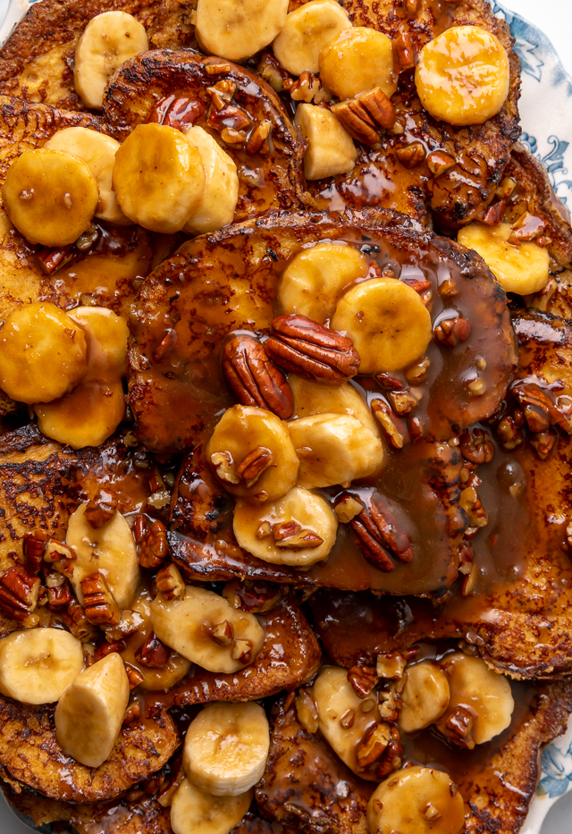 This Easy Bananas Foster French Toast is one of our favorite breakfast recipes! Crispy slices of buttery brioche are topped with a delicious homemade bananas foster sauce made from dark rum, butter, brown sugar, heavy cream, and crunchy pecans. Delicious on it's on, but devilishly good with whipped cream or vanilla ice cream!