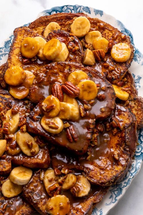 This Easy Bananas Foster French Toast is one of our favorite breakfast recipes! Crispy slices of buttery brioche are topped with a delicious homemade bananas foster sauce made from dark rum, butter, brown sugar, heavy cream, and crunchy pecans. Delicious on it's on, but devilishly good with whipped cream or vanilla ice cream!