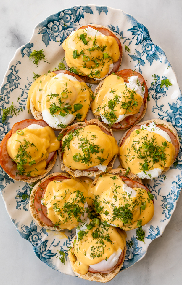 Featuring golden brown toasted English muffins, poached eggs, slices of Canadian bacon, and hollandaise sauce, this Eggs Benedict recipe is pure perfection! Top with freshly chopped dill and scallions, or simply serve with salt and pepper. Perfect for any special at-home breakfast or brunch!