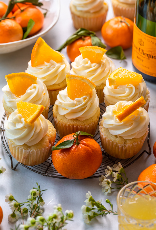 Today I'm teaching you how to make Mimosa Cupcakes! Light and fluffy, these delicious cupcakes are made with freshly squeezed orange juice, orange zest, and of course, CHAMPAGNE! One of my favorite cupcake recipes for brunch or special occasions like Easter, Mother's Day, or New Year's Eve!